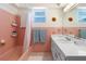 This charming bathroom features beautiful tiling, vanity with sink, tub and a large mirror at 4262 Cardinal Blvd, Port Orange, FL 32127