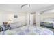 This bedroom features a mirrored closet, tiled floors, and ample lighting at 4262 Cardinal Blvd, Port Orange, FL 32127