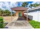 Charming covered carport with a bright teal door, adding a pop of color to the exterior at 4262 Cardinal Blvd, Port Orange, FL 32127
