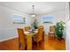 Cozy dining area with bamboo chairs, hardwood floors, and natural lighting from the windows at 4262 Cardinal Blvd, Port Orange, FL 32127