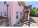 Back entrance with stairs, an outdoor shower, and tropical foliage at 4262 Cardinal Blvd, Port Orange, FL 32127