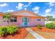 Charming single-story home featuring a well-manicured lawn, vibrant landscaping and decorative door at 4262 Cardinal Blvd, Port Orange, FL 32127