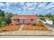 Charming pink single-story home with well-maintained landscaping and bright turquoise door at 4262 Cardinal Blvd, Port Orange, FL 32127
