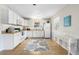 Well-lit kitchen with white cabinets, tiled floors, and a window over the sink at 4262 Cardinal Blvd, Port Orange, FL 32127