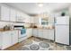 Well-maintained kitchen featuring white appliances, ample counter space, and tile flooring at 4262 Cardinal Blvd, Port Orange, FL 32127