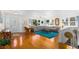 Spacious living room with hardwood floors, a comfortable sectional sofa, and large windows at 4262 Cardinal Blvd, Port Orange, FL 32127