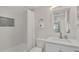 Bright bathroom featuring a tub with white tile and a single sink vanity at 4307 Sea Mist Dr # 135, New Smyrna Beach, FL 32169