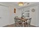 Charming dining room featuring neutral walls, wood-look flooring, natural light, and a stylish light fixture at 4307 Sea Mist Dr # 135, New Smyrna Beach, FL 32169