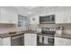 Well-equipped kitchen featuring white cabinets, stainless steel appliances, and dark countertops at 4307 Sea Mist Dr # 135, New Smyrna Beach, FL 32169