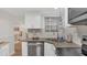 Well-equipped kitchen featuring stainless steel appliances, wood-look flooring, and bright white cabinets at 4307 Sea Mist Dr # 135, New Smyrna Beach, FL 32169