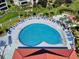 A heart-shaped community pool is accented by lounge chairs, lush greenery, and a nearby clubhouse at 438 Bouchelle Dr # 104, New Smyrna Beach, FL 32169
