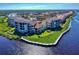 Aerial view of waterfront condos with beautiful landscaping and scenic water views at 438 Bouchelle Dr # 104, New Smyrna Beach, FL 32169