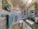 Bathroom with a seashell-themed mirror, wood-style wall paneling, and shower-tub combo at 438 Bouchelle Dr # 104, New Smyrna Beach, FL 32169