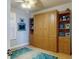 Bedroom with hardwood floors and custom-built wall unit for ample storage and display at 438 Bouchelle Dr # 104, New Smyrna Beach, FL 32169