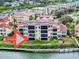 Beautiful waterfront condo building with lush landscaping and private docks along the waterfront at 438 Bouchelle Dr # 104, New Smyrna Beach, FL 32169