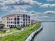 Waterfront condos with well-manicured landscaping and a wooden boardwalk along the shoreline at 438 Bouchelle Dr # 104, New Smyrna Beach, FL 32169