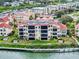Beautiful waterfront condo building with lush landscaping and private docks along the waterfront at 438 Bouchelle Dr # 104, New Smyrna Beach, FL 32169