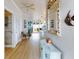 Inviting hallway featuring coastal decor, light hardwood flooring, and access to multiple living spaces at 438 Bouchelle Dr # 104, New Smyrna Beach, FL 32169