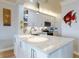 Contemporary kitchen featuring white cabinets, granite countertops, and stainless steel appliances at 438 Bouchelle Dr # 104, New Smyrna Beach, FL 32169