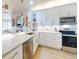 Modern kitchen with white cabinets, stainless steel appliances, and eat-in counter space at 438 Bouchelle Dr # 104, New Smyrna Beach, FL 32169