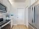 Charming kitchen featuring stainless steel appliances, white cabinets, and light hardwood flooring at 438 Bouchelle Dr # 104, New Smyrna Beach, FL 32169