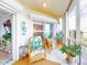 Comfortable lanai featuring stylish seating, a decorative turtle wall art, and natural light at 438 Bouchelle Dr # 104, New Smyrna Beach, FL 32169