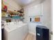 Functional laundry room with shelving, washer, dryer, and storage space for household needs at 438 Bouchelle Dr # 104, New Smyrna Beach, FL 32169