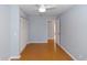 A bright bedroom with a ceiling fan, closet, and wood floors at 4431 Doris Dr, New Smyrna Beach, FL 32169
