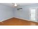 Bright bedroom features wood floors, fan, and sliding glass door at 4431 Doris Dr, New Smyrna Beach, FL 32169