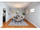 The dining area features laminate flooring, neutral walls, and is decorated with a modern table at 4431 Doris Dr, New Smyrna Beach, FL 32169