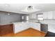 Bright kitchen features white cabinets, quartz countertops, stainless steel appliances, and ample countertop space at 4431 Doris Dr, New Smyrna Beach, FL 32169