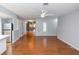 Spacious living room features wood-look flooring, a ceiling fan, and natural light at 4431 Doris Dr, New Smyrna Beach, FL 32169
