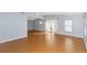 Open-concept living room with vaulted ceiling, laminate flooring, ceiling fan, and ample natural light at 4431 Doris Dr, New Smyrna Beach, FL 32169