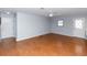 Spacious living room features wood-look flooring, a ceiling fan, and natural light at 4431 Doris Dr, New Smyrna Beach, FL 32169