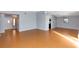 Bright living room with laminate flooring, neutral paint, and an open layout to the entryway and dining area at 4431 Doris Dr, New Smyrna Beach, FL 32169
