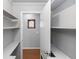 Pantry with white shelving and view of a stained glass window at 4431 Doris Dr, New Smyrna Beach, FL 32169