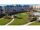 Beautiful building with a manicured lawn, palm trees and direct access to the pool at 4501 S Atlantic Ave # 5060, New Smyrna Beach, FL 32169