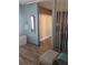 Hallway features hardwood floors, a wall mirror, and a view into the living room at 4501 S Atlantic Ave # 5060, New Smyrna Beach, FL 32169