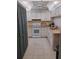 Compact kitchen features white cabinetry, appliances, a ceiling fan, and neutral countertops at 4501 S Atlantic Ave # 5060, New Smyrna Beach, FL 32169