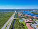 Gorgeous aerial shot of a bridge and community with a pool, tennis court, and water views at 468 Bouchelle Dr # 128, New Smyrna Beach, FL 32169