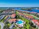 Stunning aerial view of a condo community with a waterfront, club house, community pool and landscaped grounds at 468 Bouchelle Dr # 128, New Smyrna Beach, FL 32169