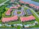 Great aerial view of condos near a lazy river with lush landscaping, parking, and nearby amenities at 468 Bouchelle Dr # 128, New Smyrna Beach, FL 32169