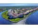 Stunning aerial view of a waterfront condominium complex on a sunny day, with manicured lawns at 468 Bouchelle Dr # 128, New Smyrna Beach, FL 32169
