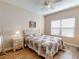 Cozy bedroom featuring a floral-patterned bed, nightstand, and plenty of natural light at 468 Bouchelle Dr # 128, New Smyrna Beach, FL 32169