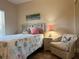 Cozy bedroom with light walls, a comfortable chair, and decorative accents at 468 Bouchelle Dr # 128, New Smyrna Beach, FL 32169