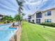 Attractive condo exterior featuring a lazy river, lush landscaping, and well-maintained grounds at 468 Bouchelle Dr # 128, New Smyrna Beach, FL 32169