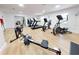 Bright workout room featuring modern exercise equipment, including treadmills, elliptical, rowing machine, and stationary bikes at 468 Bouchelle Dr # 128, New Smyrna Beach, FL 32169
