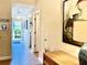 Bright hallway featuring tile flooring and walls adorned with artistic decor and decorative lamp at 468 Bouchelle Dr # 128, New Smyrna Beach, FL 32169