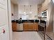 Functional kitchen featuring wood cabinets, stainless steel appliances, and a convenient breakfast bar at 468 Bouchelle Dr # 128, New Smyrna Beach, FL 32169