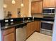 Well-equipped kitchen featuring stainless steel appliances, dark granite countertops, and wood cabinets at 468 Bouchelle Dr # 128, New Smyrna Beach, FL 32169